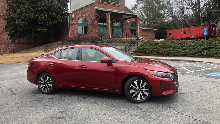 Nissan Sentra SV in scarlet ember tintcoat parked outside.